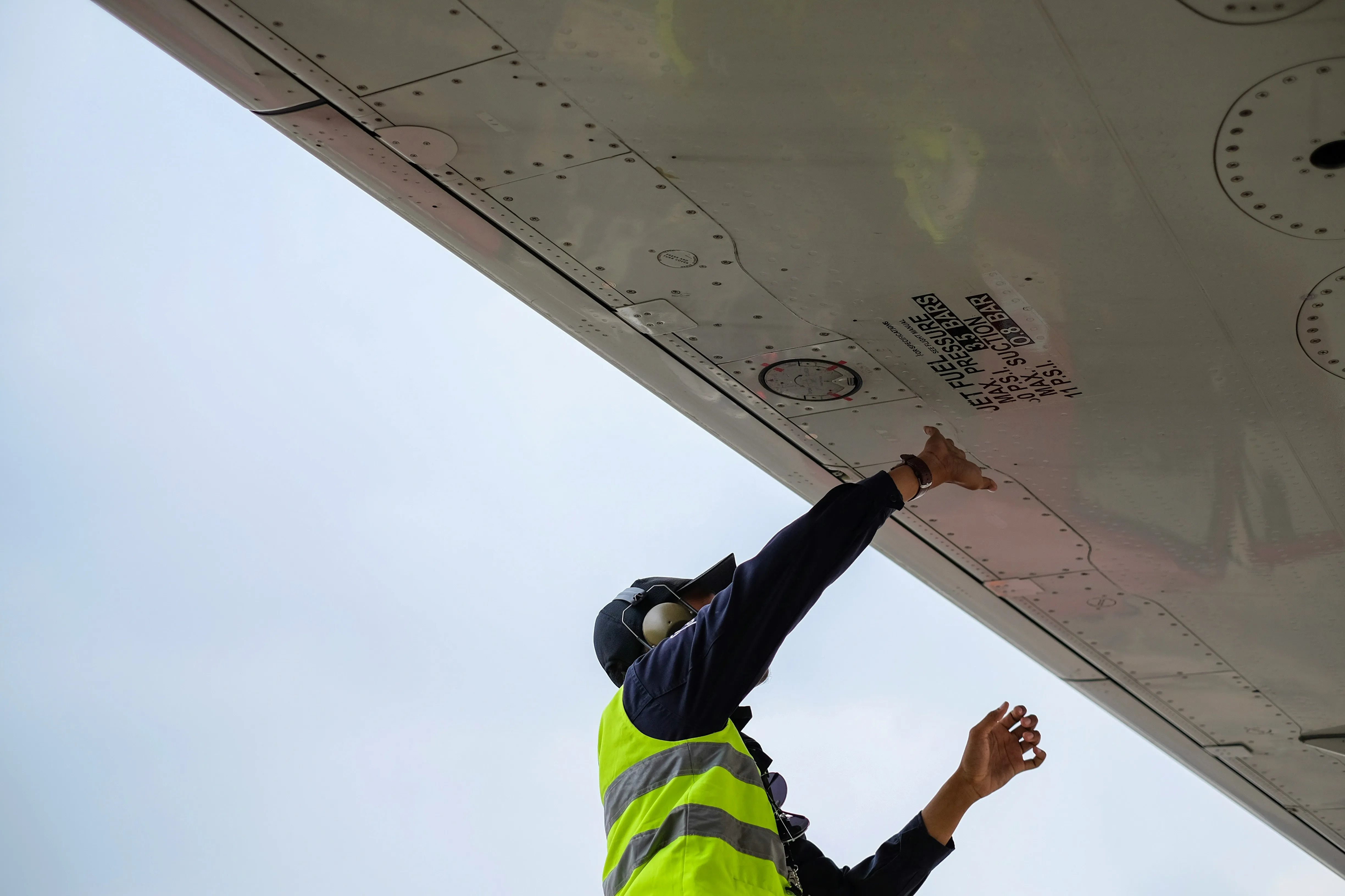 A close-up of an aircraft engineer at work